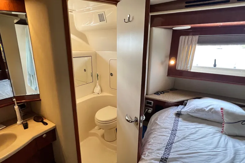 Slide: The Image of 2003 Sea Ray 480 Motor Yacht interior with cozy bedroom and compact bathroom. - 133