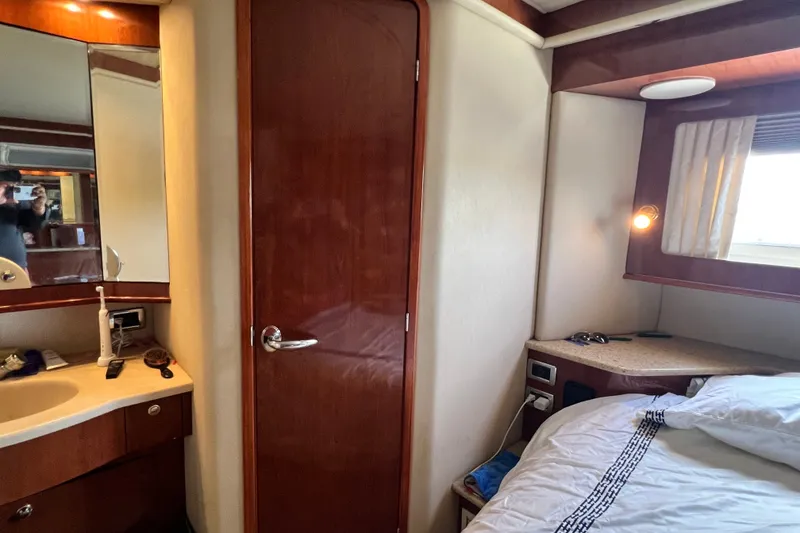 Slide: The Image of Interior of 2003 Sea Ray 480 Motor Yacht cabin with bed and vanity area. - 131