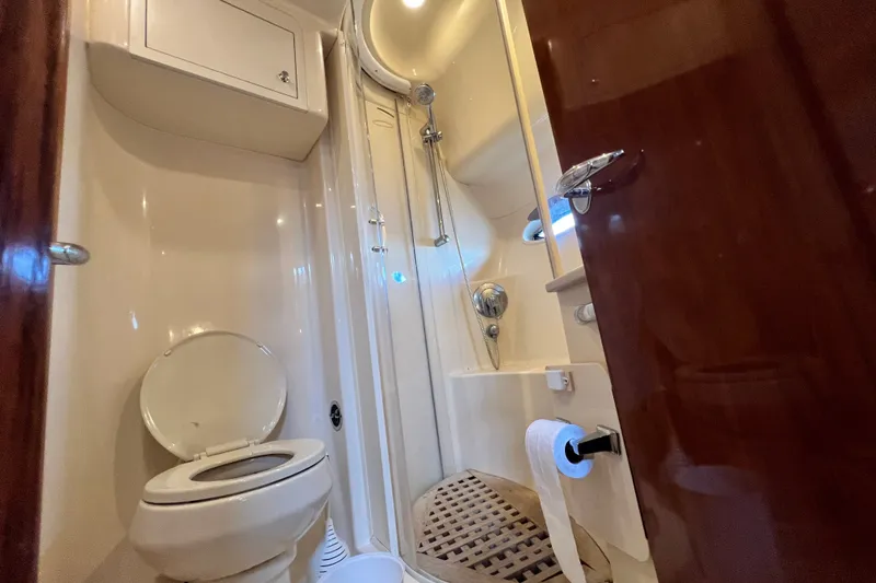 Slide: The Image of Bathroom interior of 2003 Sea Ray 480 Motor Yacht, featuring shower and toilet. - 110