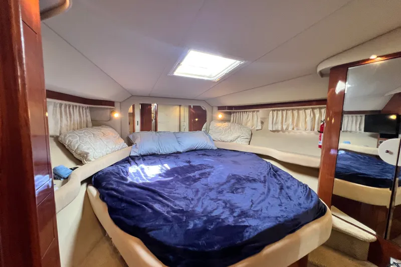 Slide: The Image of Luxurious bedroom interior of 2003 Sea Ray 480 Motor Yacht with plush bedding. - 125