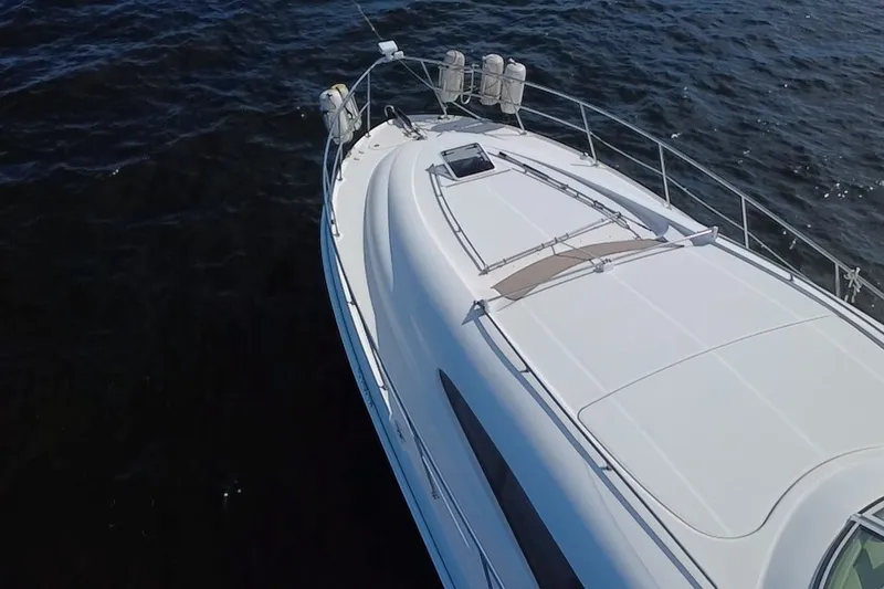 Slide: The Image of 2003 Sea Ray 480 Motor Yacht cruising on open water, aerial view. - 213