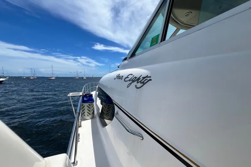 Slide: The Image of 2003 Sea Ray 480 Motor Yacht on open water under a clear blue sky. - 79