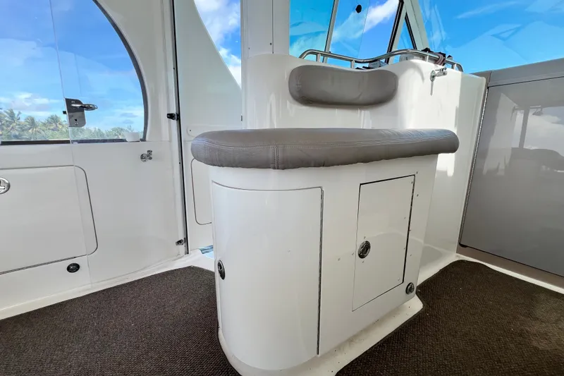 Slide: The Image of Interior view of 2003 Sea Ray 480 Motor Yacht with cushioned seating and storage. - 180
