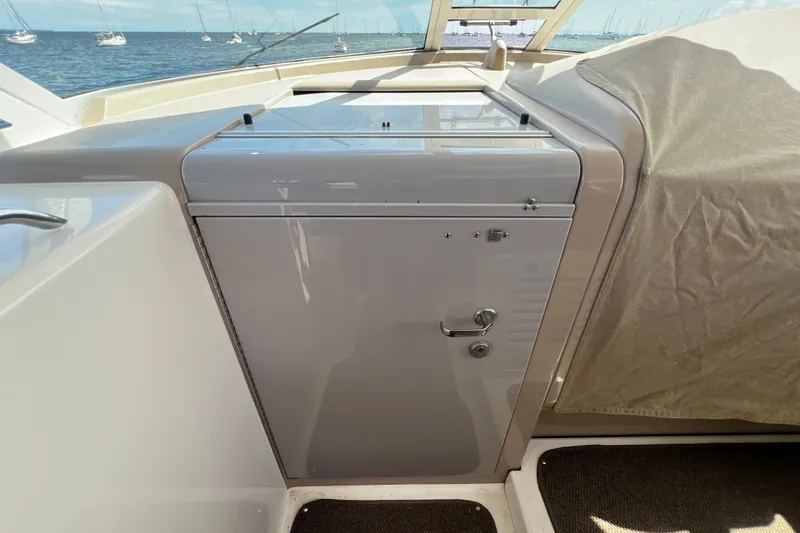 Slide: The Image of 2003 Sea Ray 480 Motor Yacht helm station with ocean view and covered seating area. - 166
