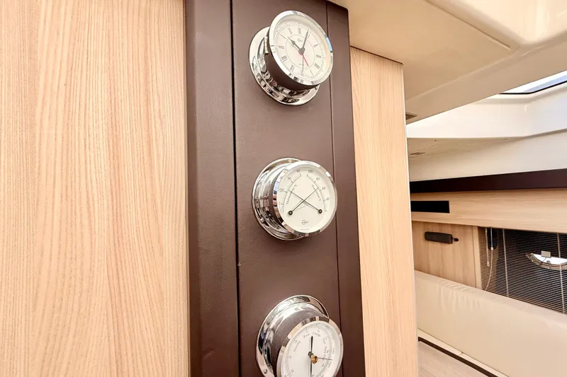 Slide: The Image of Interior of 2016 Cranchi M44 HT yacht with elegant wooden paneling and chrome gauges. - 64
