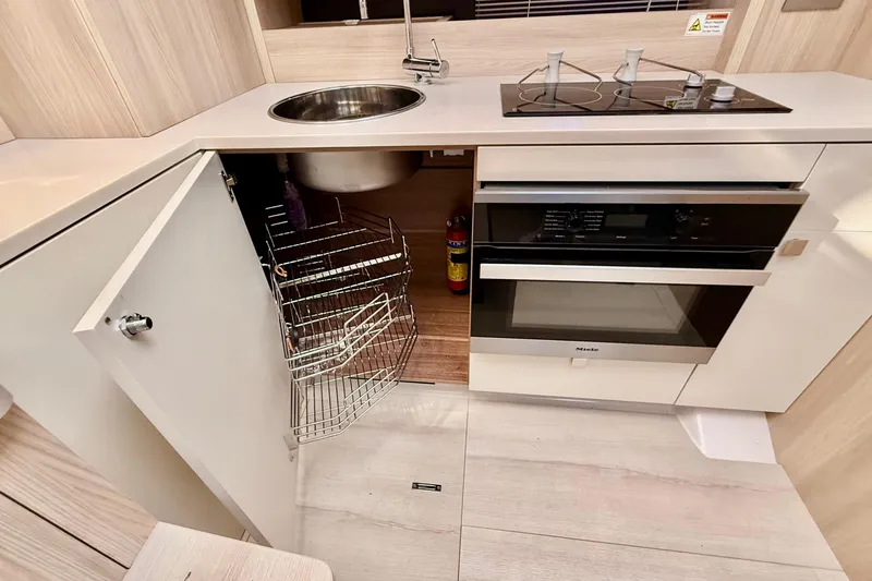 Slide: The Image of Modern kitchen in 2016 Cranchi M44 HT yacht with stove, oven, and storage. - 51