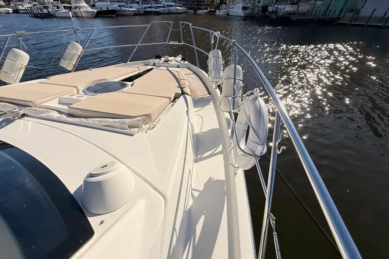 Slide: The Image of 2016 Cranchi M44 HT yacht deck with sun loungers and water reflections. - 147
