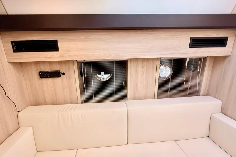 Slide: The Image of Interior of 2016 Cranchi M44 HT yacht with beige seating and wooden paneling. - 87