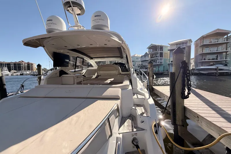 Slide: The Image of 2016 Cranchi M44 HT yacht docked at marina, sunny day, modern waterfront buildings. - 142