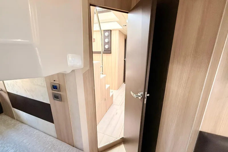 Slide: The Image of Interior view of 2016 Cranchi M44 HT yacht, featuring wooden finishes and modern design. - 128