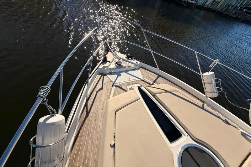 Slide: The Image of Bow view of 2016 Cranchi M44 HT yacht with sunlit water reflections. - 152