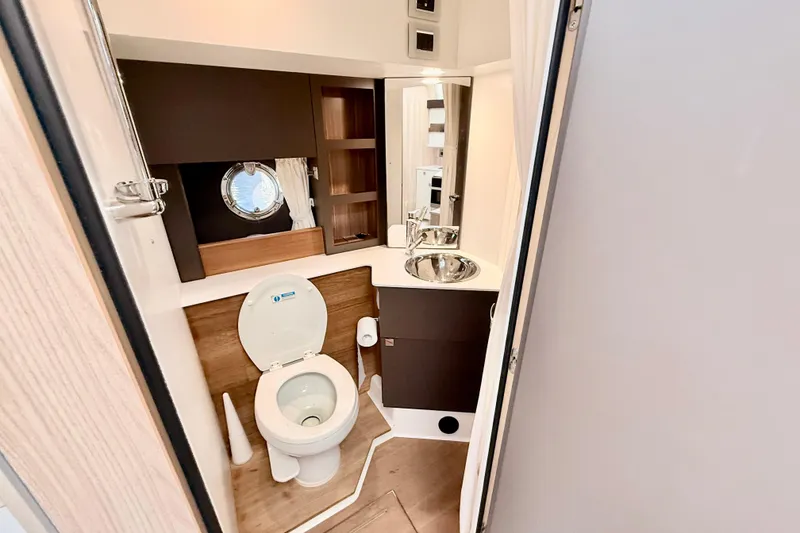 Slide: The Image of Bathroom interior of 2016 Cranchi M44 HT yacht with modern fixtures and porthole window. - 113