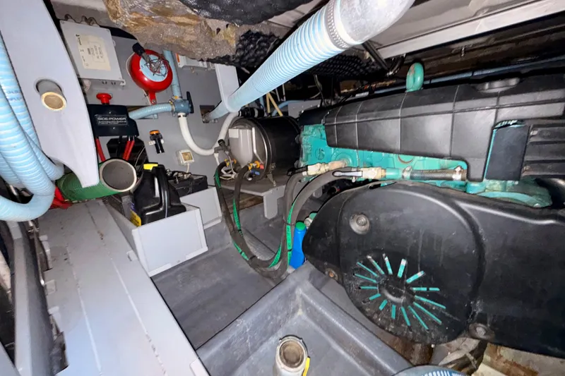 Slide: The Image of Engine room of 2016 Cranchi M44 HT yacht, showcasing mechanical components and hoses. - 160
