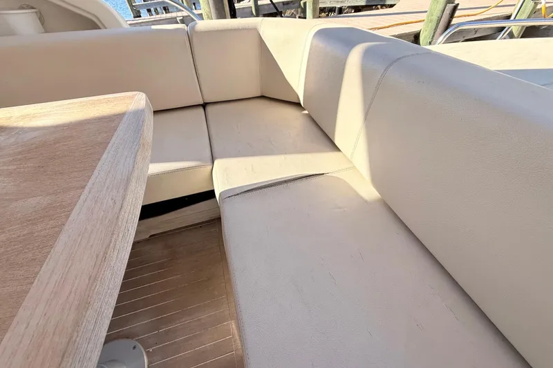 Slide: The Image of Beige seating area on 2016 Cranchi M44 HT yacht with wooden table. - 156