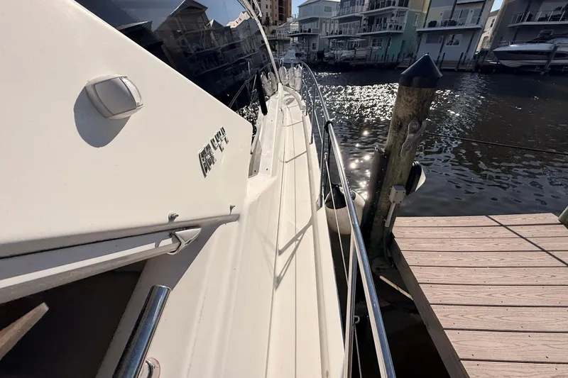 Slide: The Image of 2016 Cranchi M44 HT yacht docked by waterfront homes. - 144