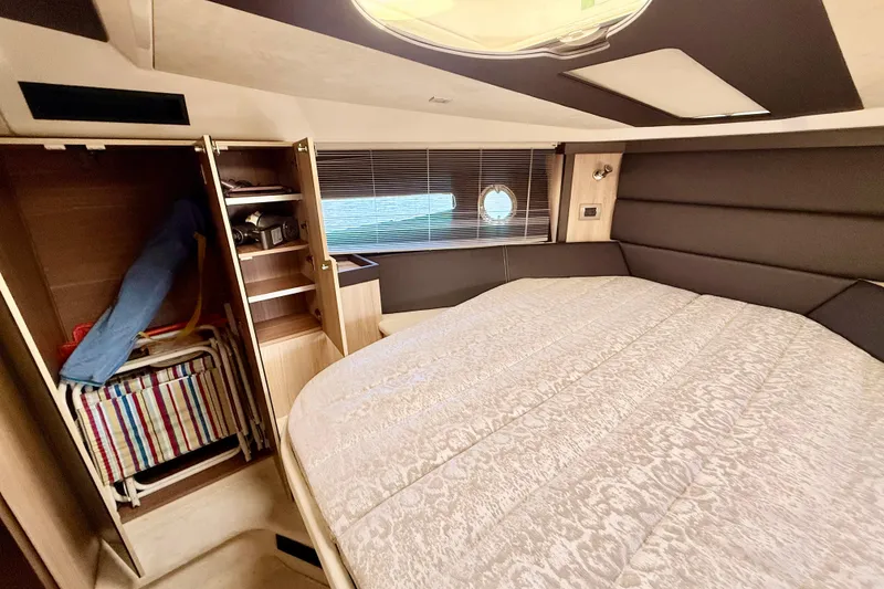 Slide: The Image of Luxurious cabin interior of 2016 Cranchi M44 HT yacht with bed and storage. - 99