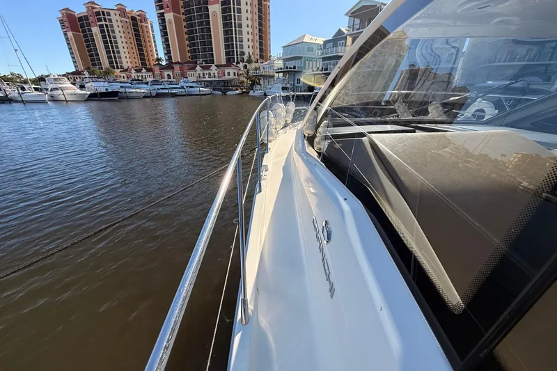 Slide: The Image of 2016 Cranchi M44 HT yacht docked near waterfront buildings and marina. - 154