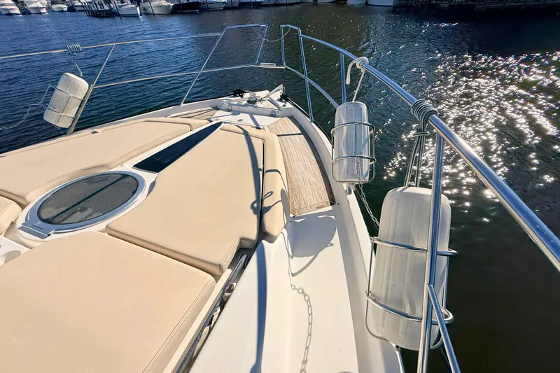 Slide: The Image of 2016 Cranchi M44 HT yacht deck with sun pads and railings on a sunny day. - 148
