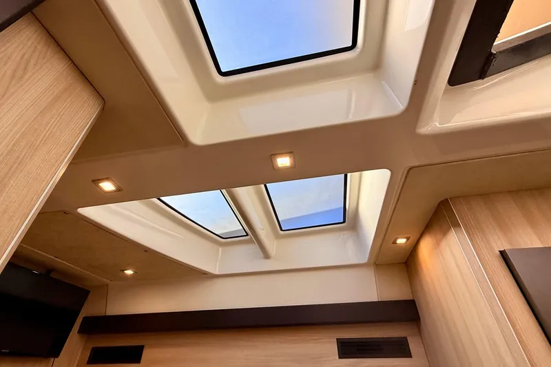 Slide: The Image of Interior view of 2016 Cranchi M44 HT yacht with skylights and wooden paneling. - 95