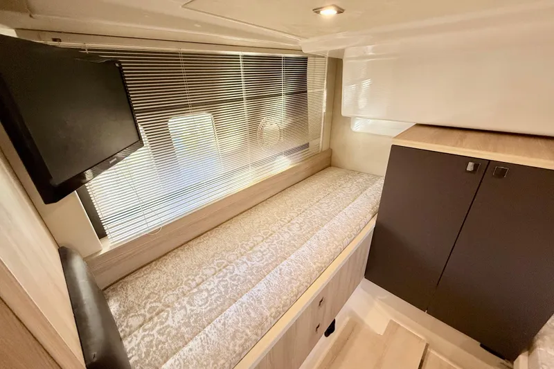 Slide: The Image of Interior of 2016 Cranchi M44 HT yacht with bed, TV, and storage cabinets. - 121