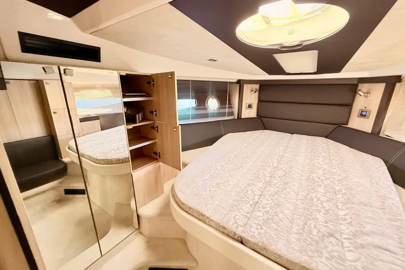 Slide: The Image of Luxurious 2016 Cranchi M44 HT yacht interior with spacious bed and modern design. - 100