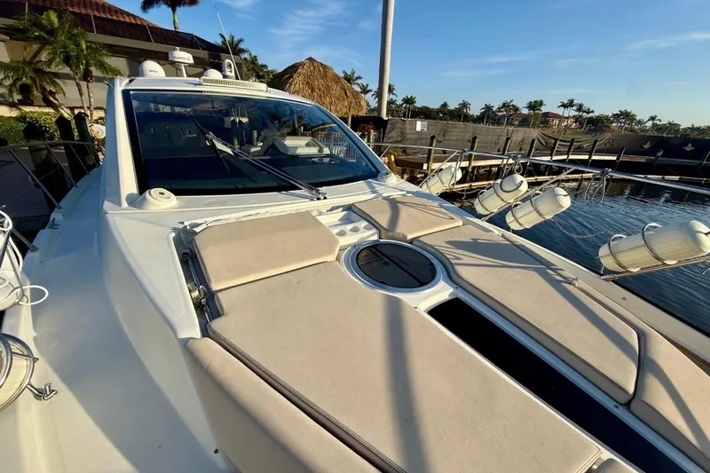 Slide: The Image of 2016 Cranchi M44 HT yacht docked, featuring sleek design and sunbathing area. - 149