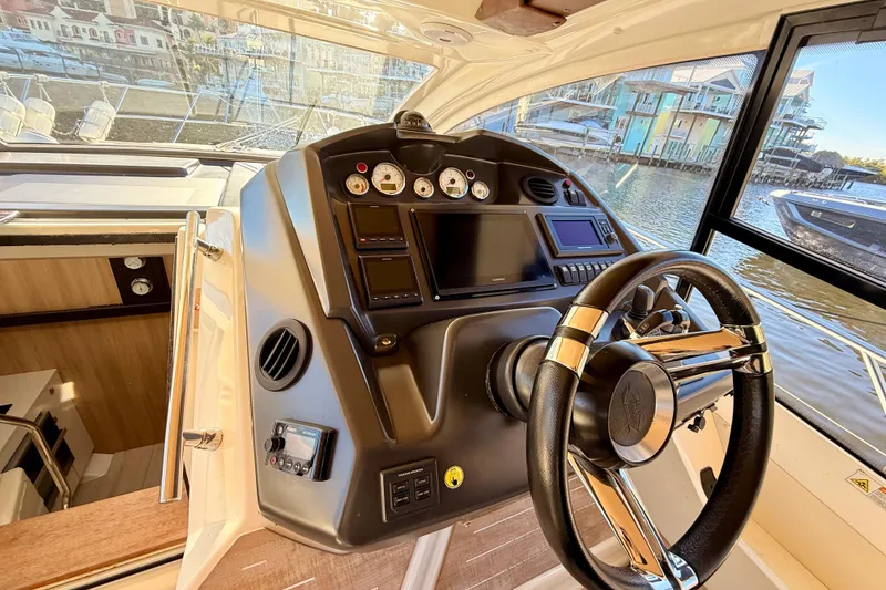 Slide: The Image of 2016 Cranchi M44 HT yacht helm with modern controls and waterfront view. - 32