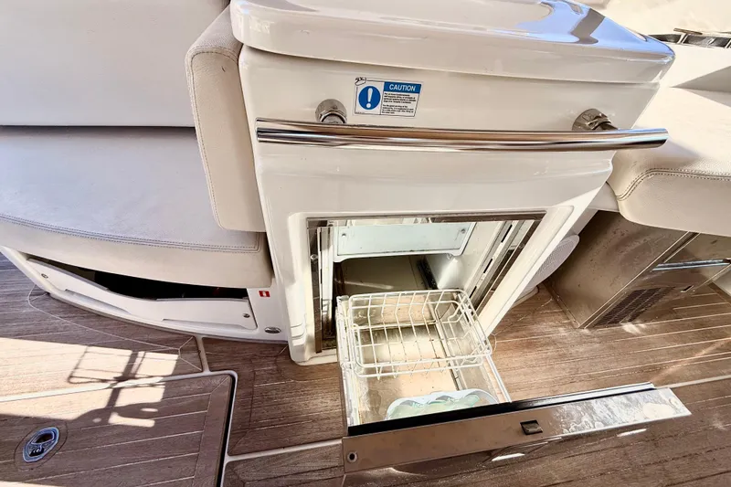 Slide: The Image of Open refrigerator on 2016 Cranchi M44 HT yacht, showcasing interior storage space. - 20