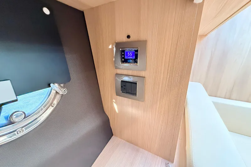 Slide: The Image of Control panel and porthole inside 2016 Cranchi M44 HT yacht cabin. - 91