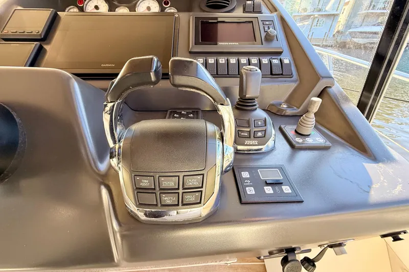 Slide: The Image of Control panel of a 2016 Cranchi M44 HT yacht with navigation and throttle controls. - 34