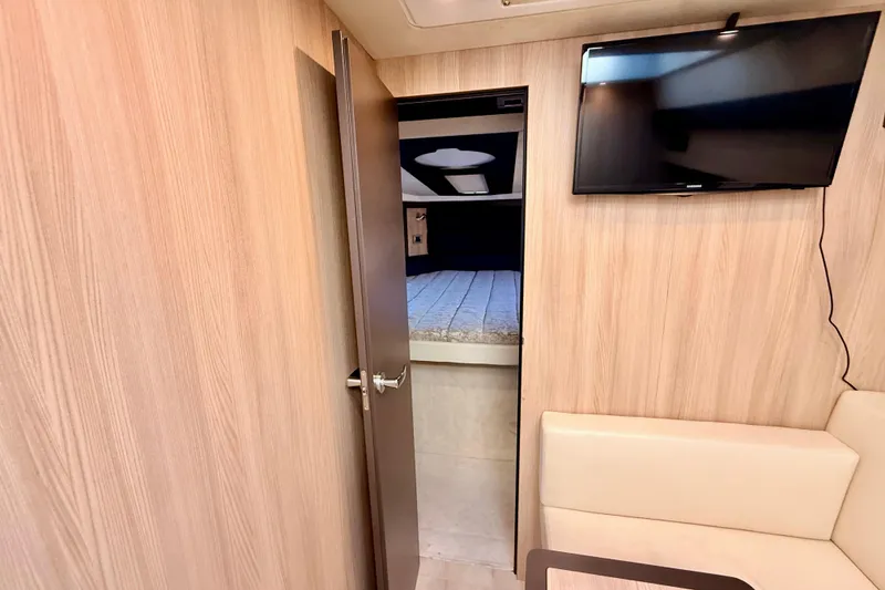 Slide: The Image of Interior of 2016 Cranchi M44 HT yacht with TV, door, and bed. - 96