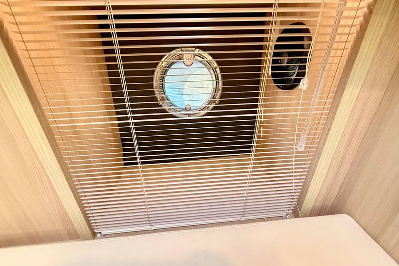 Slide: The Image of Interior of 2016 Cranchi M44 HT yacht with porthole and blinds. - 92