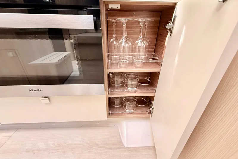 Slide: The Image of Modern kitchen cabinet with glassware storage on a 2016 Cranchi M44 HT yacht. - 59