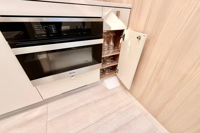 Slide: The Image of Modern kitchen in 2016 Cranchi M44 HT yacht with Miele oven and glass storage. - 58