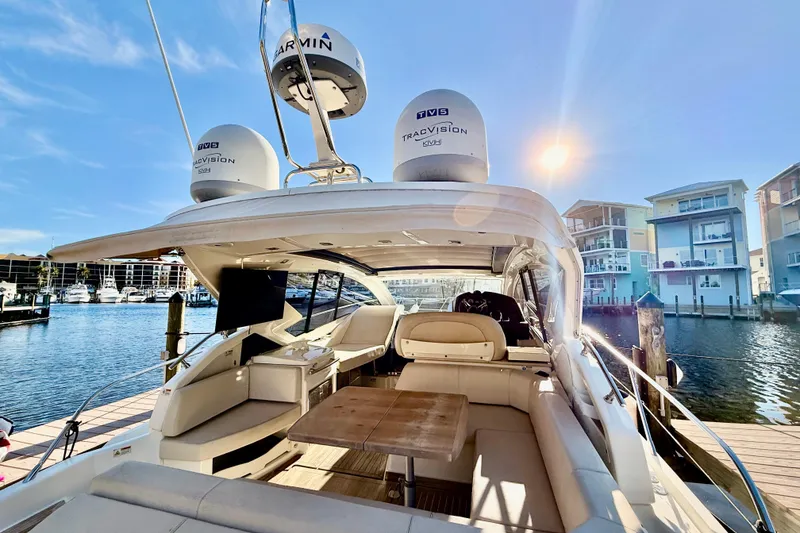 Slide: The Image of 2016 Cranchi M44 HT yacht docked, featuring spacious seating and modern navigation equipment. - 14