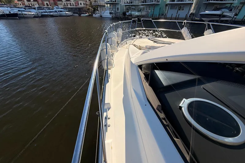 Slide: The Image of 2016 Cranchi M44 HT yacht docked in marina, showcasing sleek design and luxurious features. - 153
