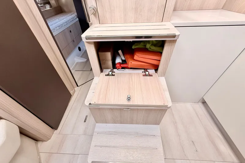 Slide: The Image of Interior storage compartment in 2016 Cranchi M44 HT yacht, featuring light wood finish and organized space. - 70