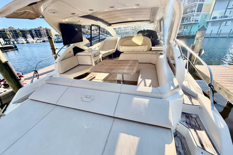 Slide: The Image of 2016 Cranchi M44 HT yacht interior with seating, table, and waterfront view. - 13