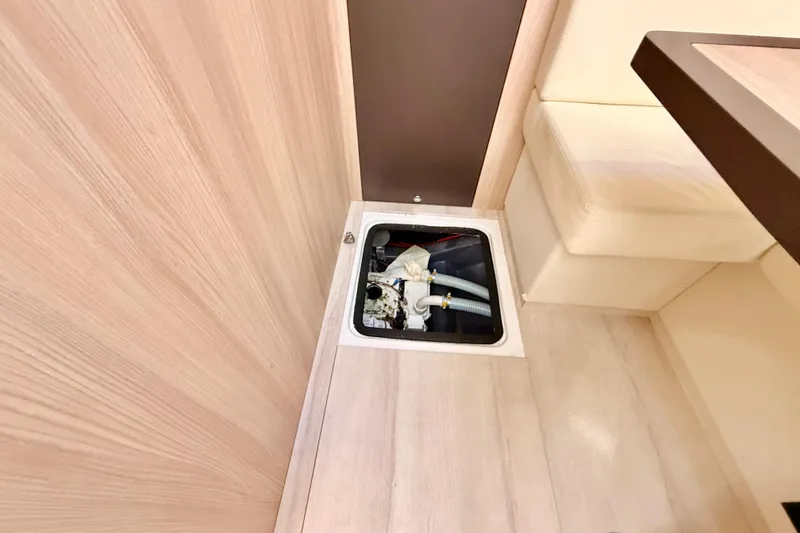 Slide: The Image of Floor compartment in 2016 Cranchi M44 HT yacht interior, showing plumbing components. - 74