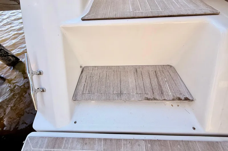 Slide: The Image of 2016 Cranchi M44 HT boat steps with wood finish near water. - 138