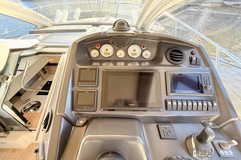 Slide: The Image of Cockpit of 2016 Cranchi M44 HT yacht with navigation controls and displays. - 33