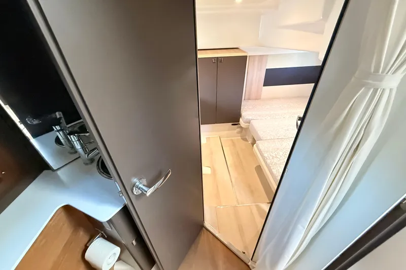 Slide: The Image of Interior view of 2016 Cranchi M44 HT yacht cabin with modern design and cozy bedding. - 119