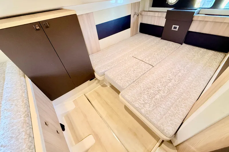 Slide: The Image of 2016 Cranchi M44 HT yacht interior with elegant bedding and wooden cabinetry. - 123