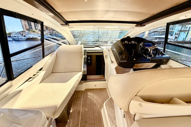 Slide: The Image of Interior view of 2016 Cranchi M44 HT yacht with helm and seating area. - 23