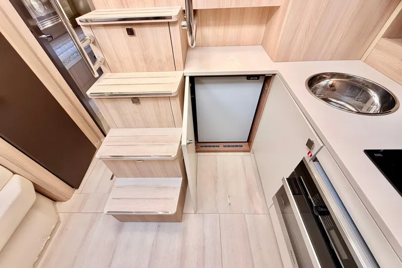 Slide: The Image of Interior of 2016 Cranchi M44 HT yacht with modern kitchen and wooden stairs. - 48