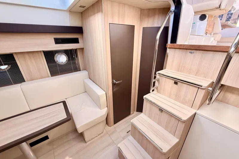 Slide: The Image of 2016 Cranchi M44 HT yacht interior with modern wood finish and seating area. - 109