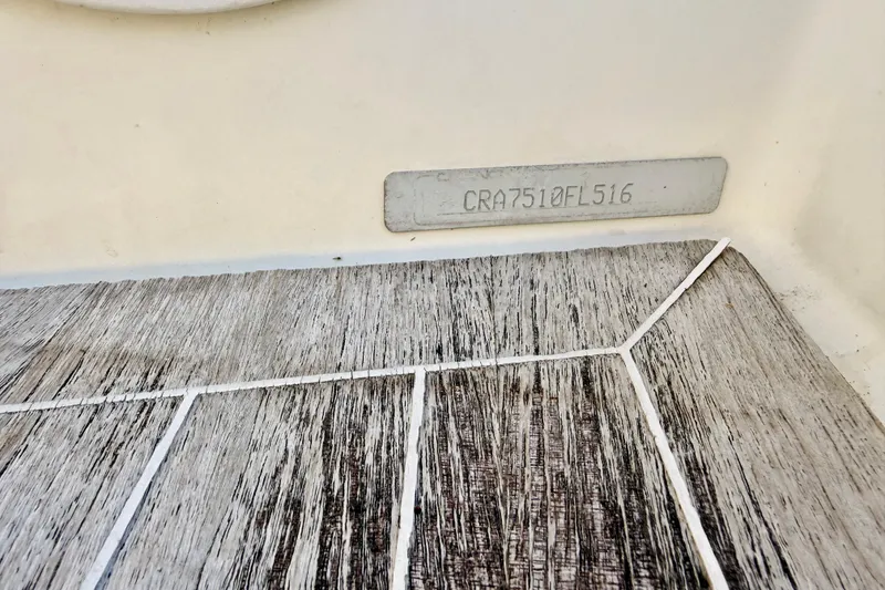 Slide: The Image of 2016 Cranchi M44 HT boat hull identification number on wooden deck. - 139