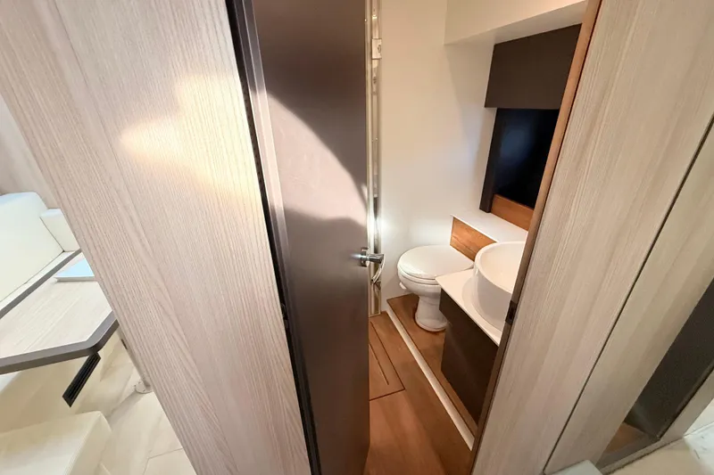 Slide: The Image of 2016 Cranchi M44 HT yacht bathroom with modern fixtures and wooden accents. - 104