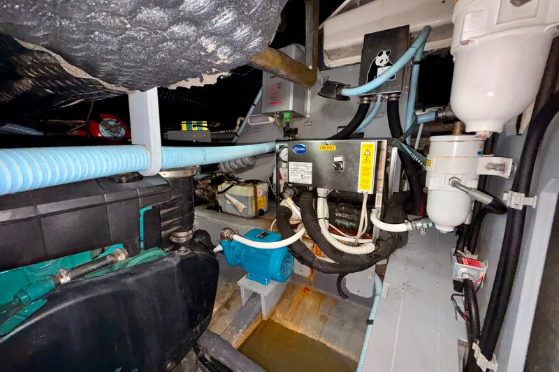 Slide: The Image of Engine room of 2016 Cranchi M44 HT yacht, showcasing mechanical components and wiring. - 164