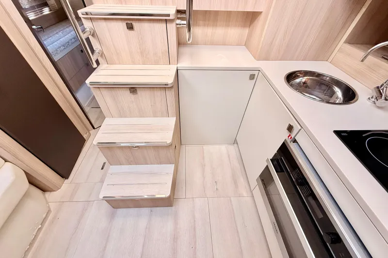 Slide: The Image of Interior of 2016 Cranchi M44 HT yacht featuring compact kitchen and wooden stairs. - 47